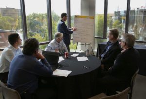 M city leadership circle meeting man at easel