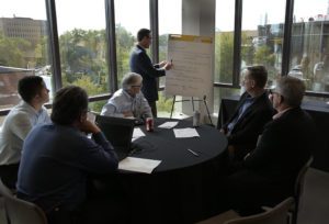 M city leadership circle meeting man at easel