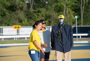 Two students at m city test facility with pedestrian robot