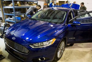 Michigan Engineering students working on car