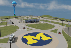 Image of Mcity Test Facility rendered by NVIDIA's Omniverse technology. The image is an overall shot showing a traffic roundabout with a large University of Michigan Block M logo in yellow against a dark blue background.
